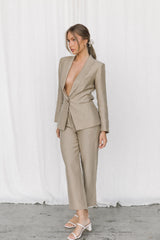 Model posing in a taupe coloured suit in a studio